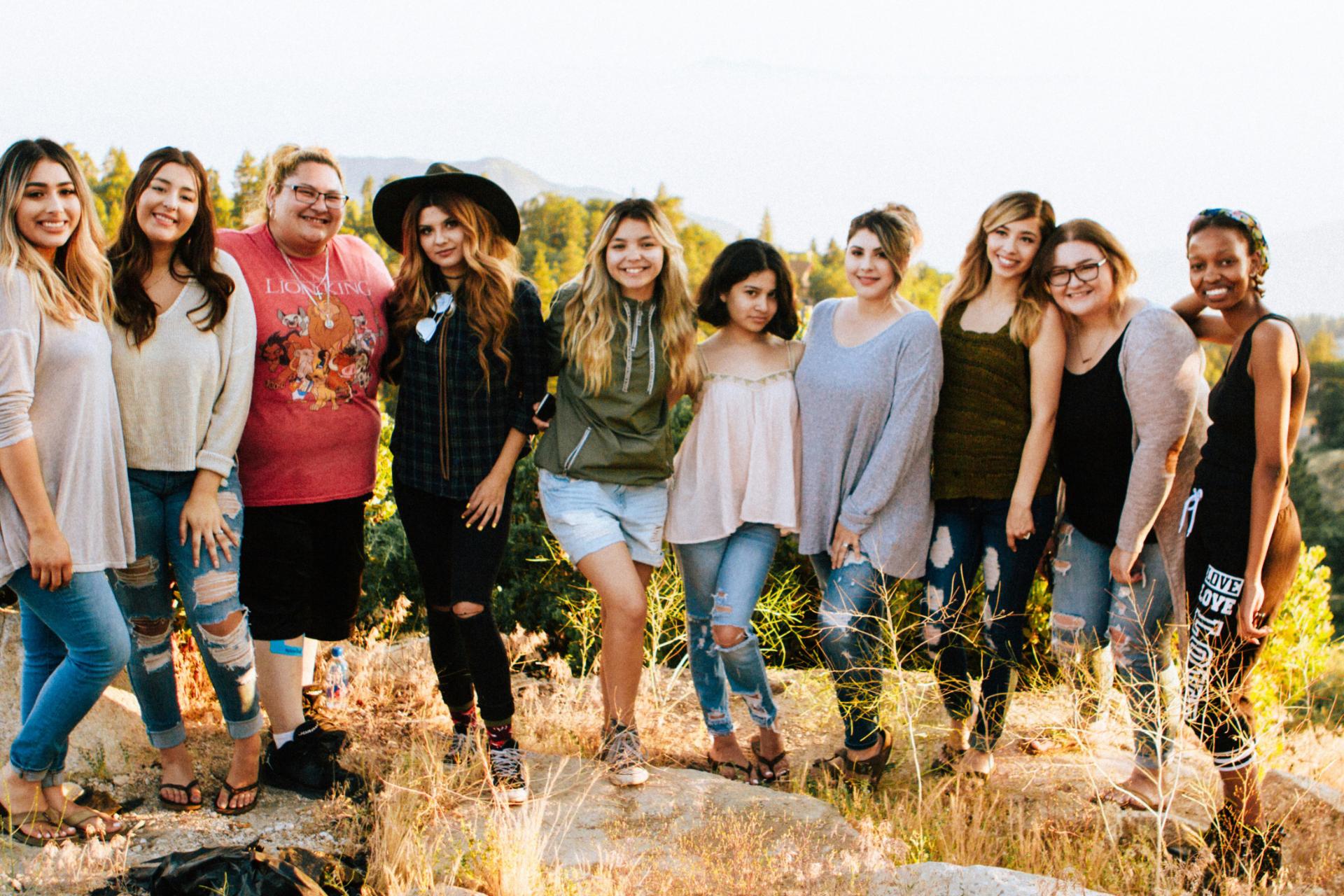 Group of women posing for a pic out in nature